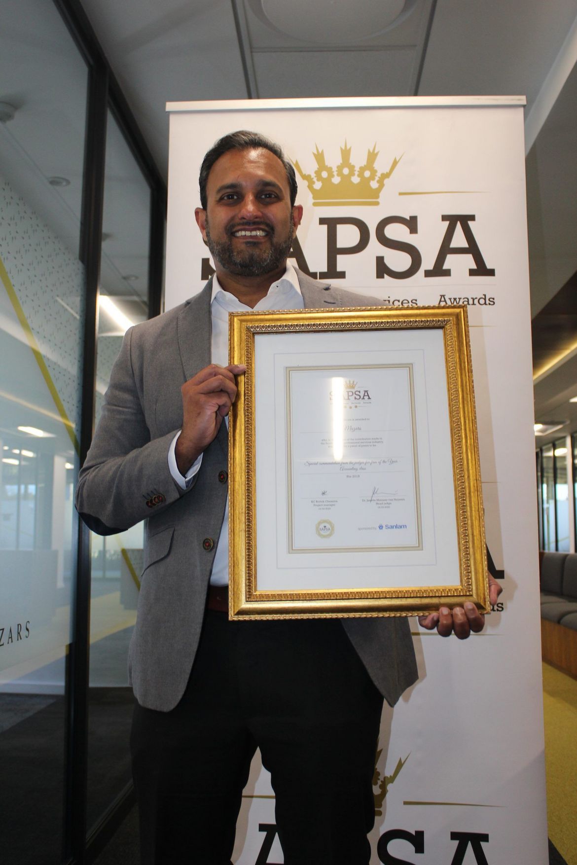 Mazars Co-CEO Anoop Ninan holding the commendation certificate.